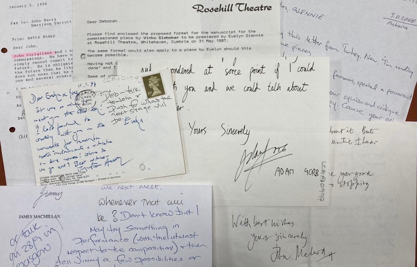 An image showing a collection of handwritten and typed letters, postcards, and notes arranged on a surface. The correspondence includes both personal and professional messages, with visible names such as James MacMillan and Rosehill Theatre. Some letters are typed on letterhead, while others are handwritten in blue ink. The materials vary in size and format, reflecting decades of communication between Dame Evelyn Glennie and composers around the world.