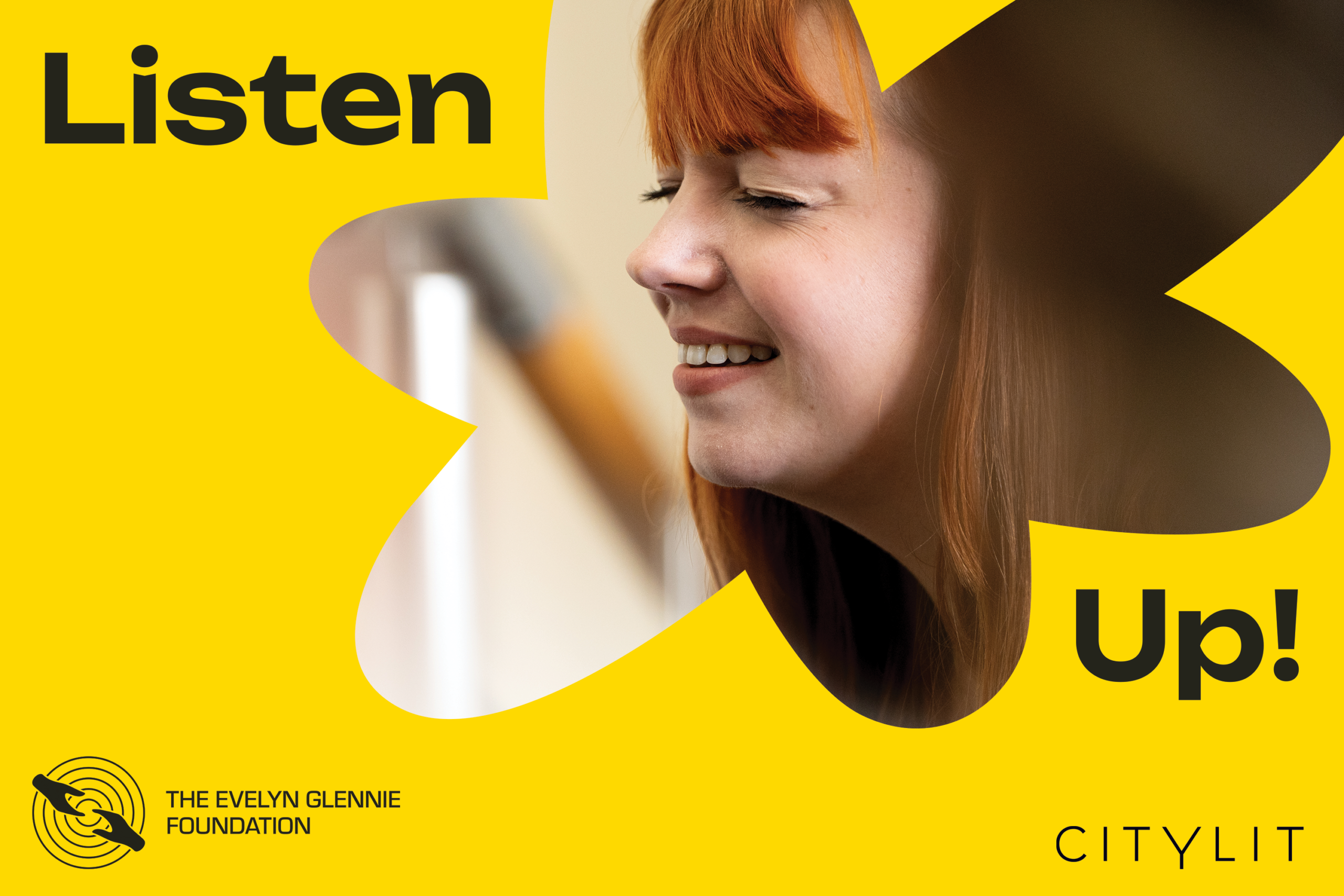 A person with long auburn hair and a fringe leans forward with their eyes closed, listening intently, set within bold yellow ‘Listen Up!’ promotional graphics featuring the City Lit and The Evelyn Glennie Foundation logos.